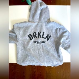 Light gray zip up hooded sweater from Artizia.